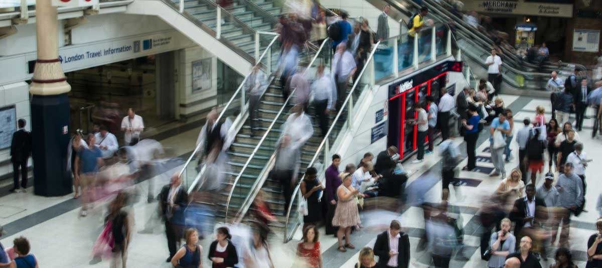 People at the mall walking up the stairs