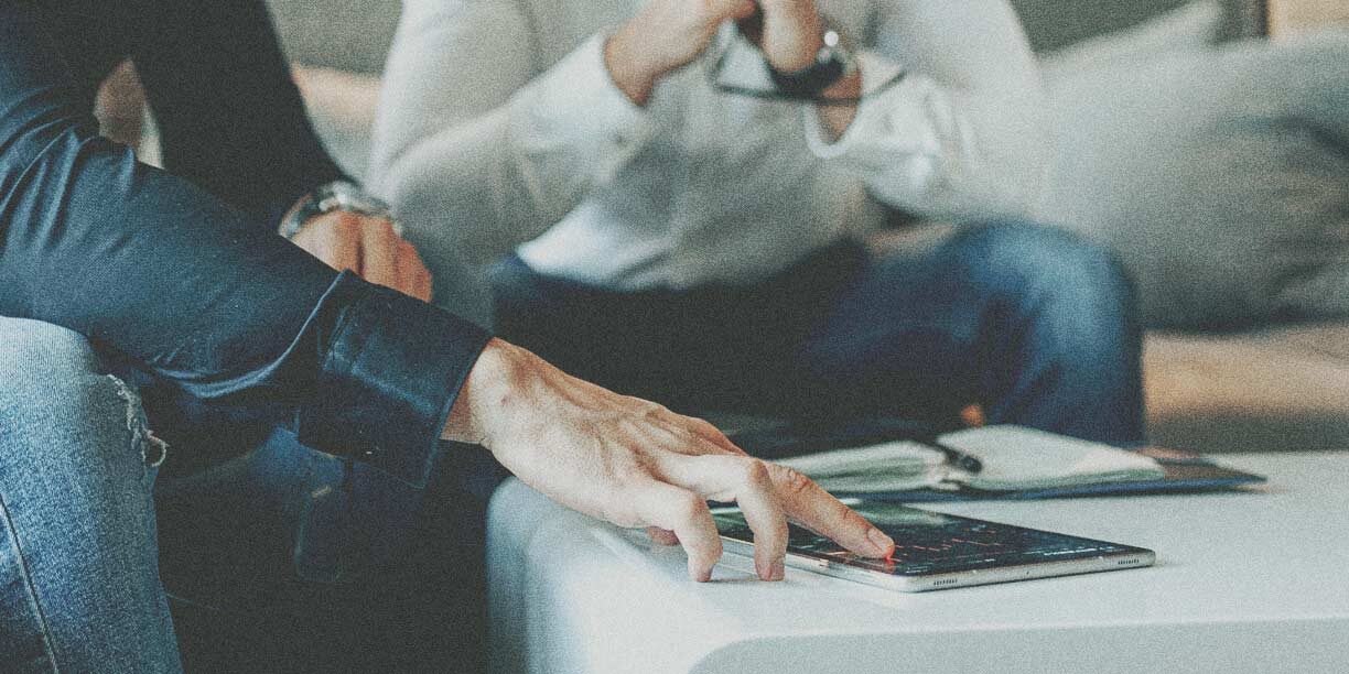 Two people looking at nonprofit ratings on a tablet