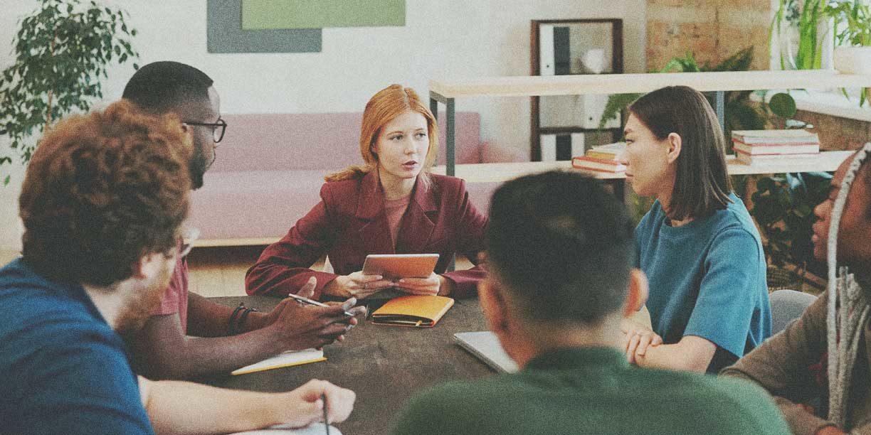 Group of employees meeting around a table