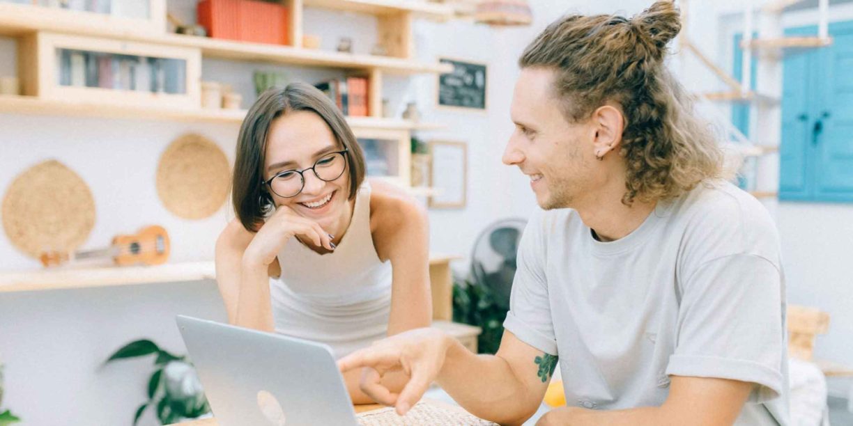 man in white t-shirt on laptop