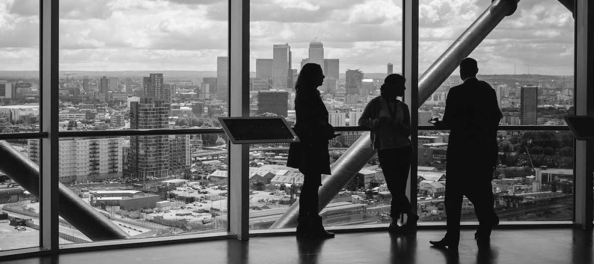 people talking in front of city view