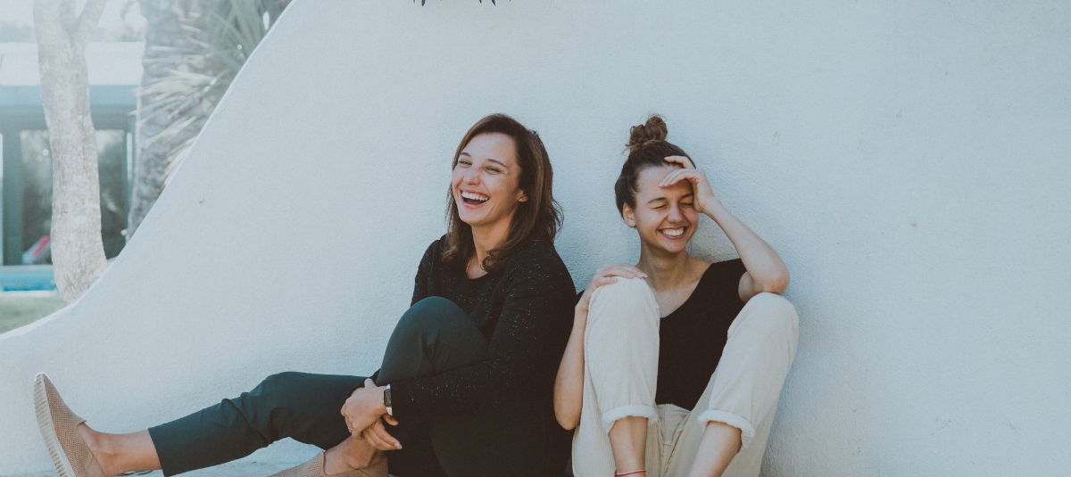 Two Women Laughing at Video