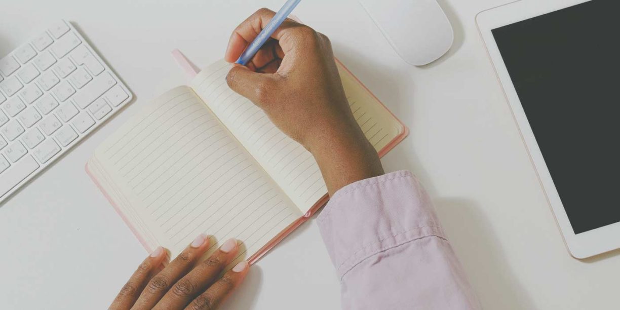 woman writing in notebook