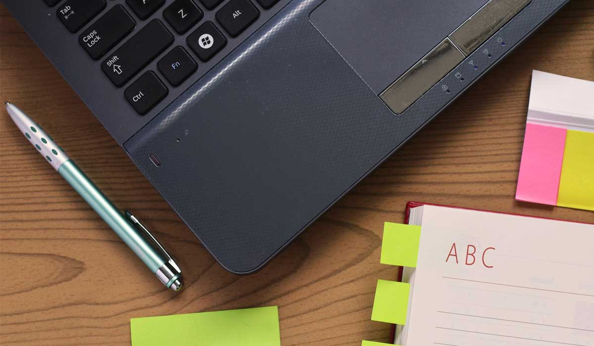 computer, sticky note, notebook