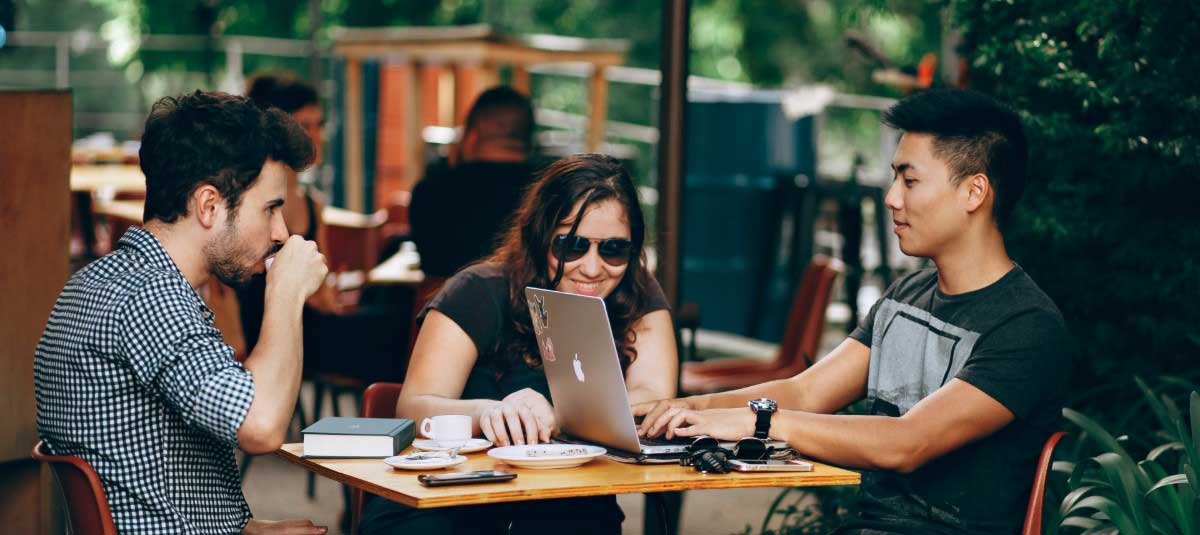 three people working in coffee shop