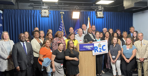 The Community Resource Center group photo at a podium