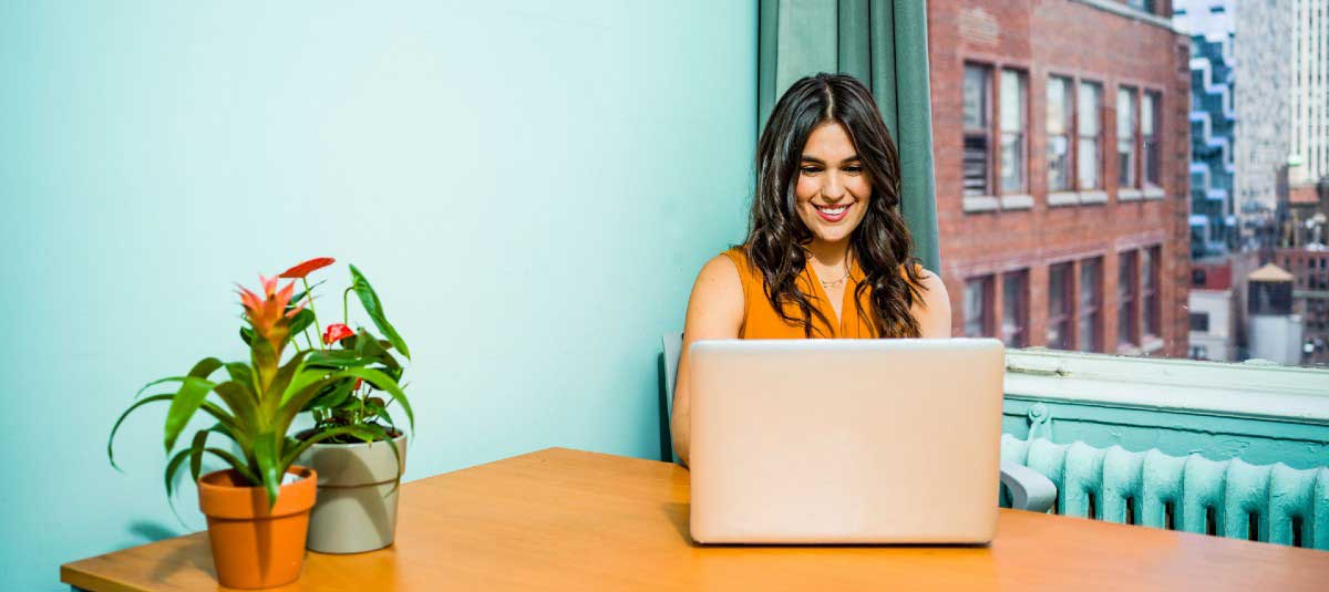 woman in blue room typing