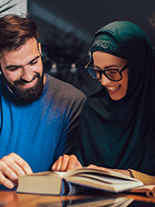 man and woman reading book