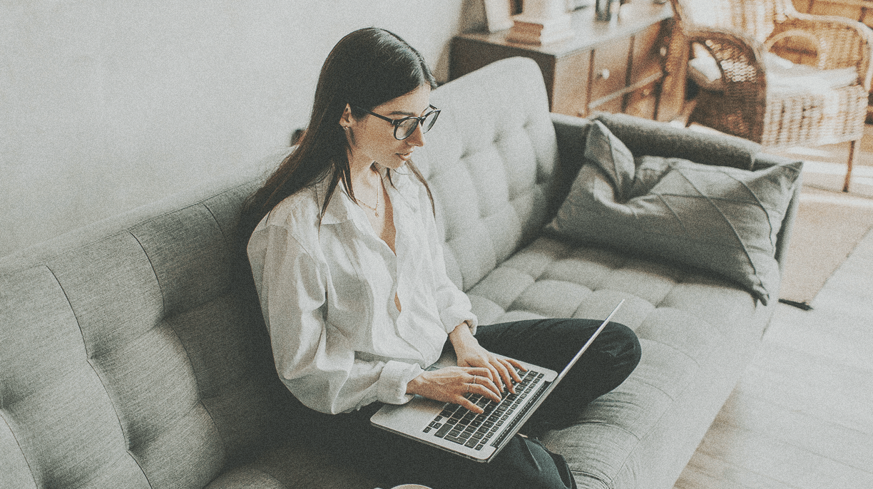 girl typing on laptop on couch