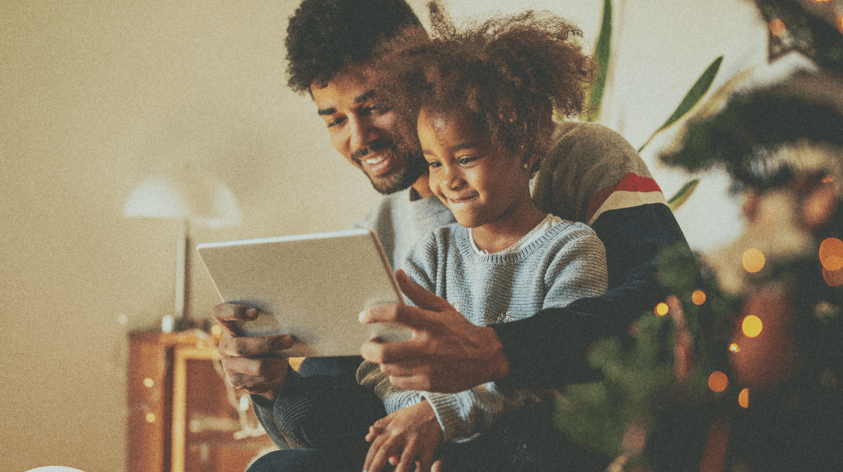 man and daughter looking at ipad